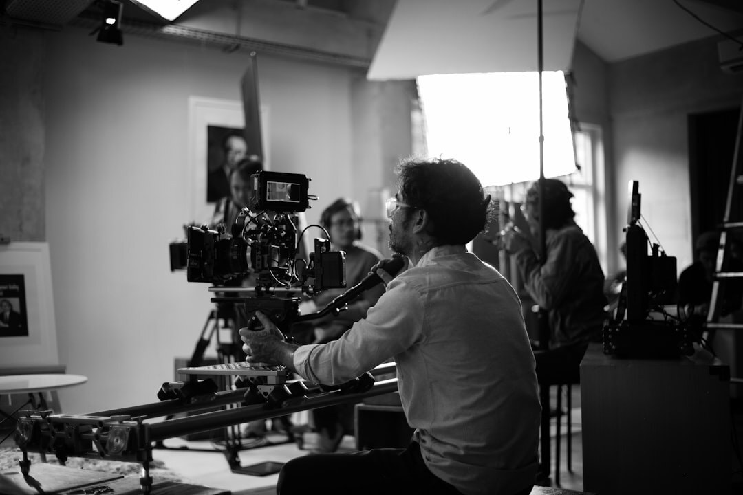 Film crew shooting a television commercial in a studio with vintage camera equipment